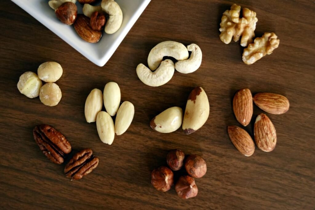 Dry fruits in bowl – almonds, walnuts, cashews, raisins and pistachios